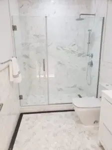 A bathroom with a toilet and shower in it