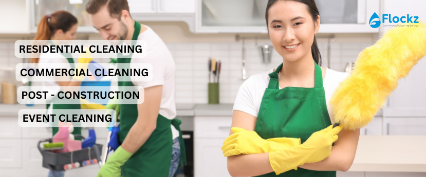 A man and woman in green aprons cleaning the kitchen.