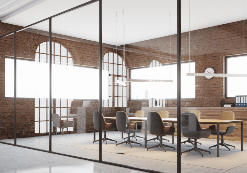 A conference room with glass walls and a table.